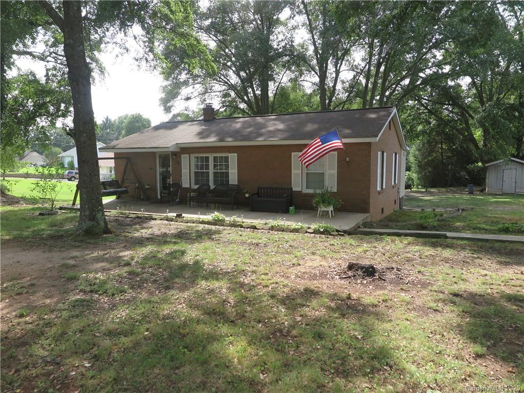 515 Upper Spencer Mountain Road Stanley, NC 28164 - Photo 1 of 28 a front view of house with yard and trees in the background