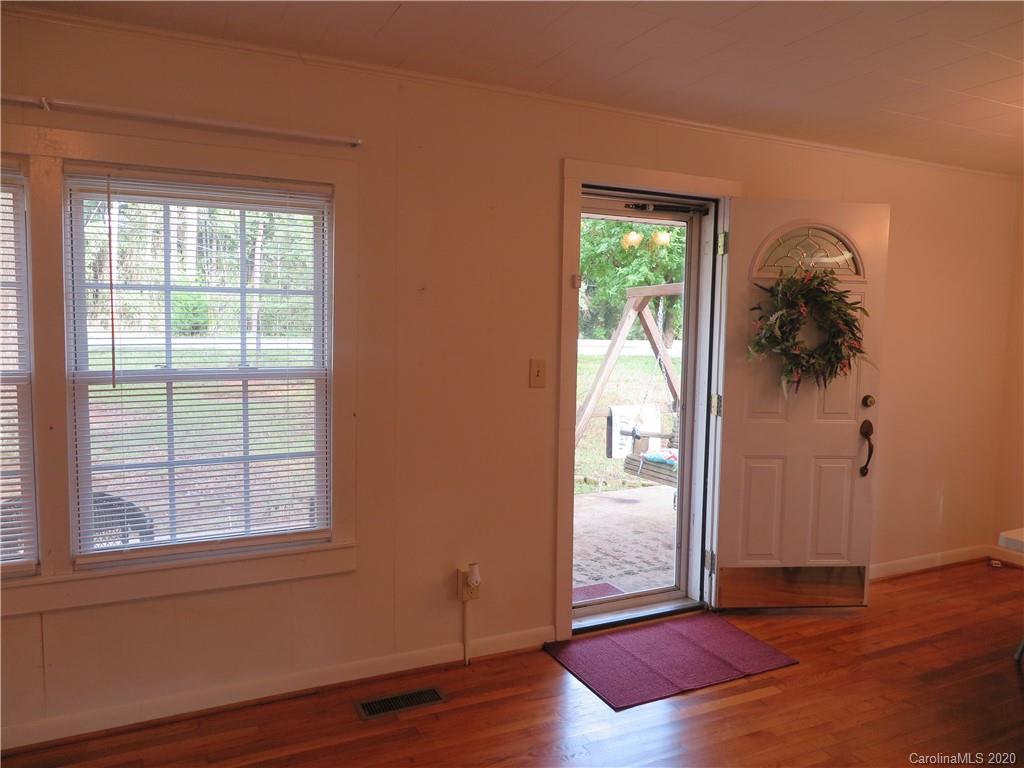 515 Upper Spencer Mountain Road Stanley, NC 28164 - Photo 2 of 28 an empty room with wooden floor and windows