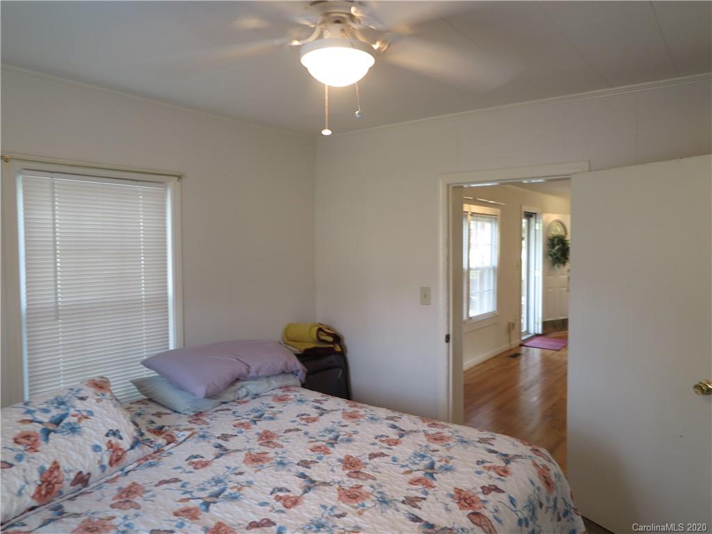 515 Upper Spencer Mountain Road Stanley, NC 28164 - Photo 13 of 28 a bedroom with a bed and a chandelier