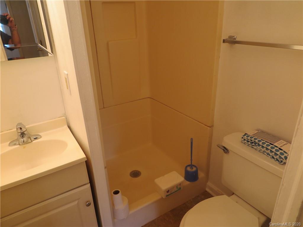 515 Upper Spencer Mountain Road Stanley, NC 28164 - Photo 18 of 28 a bathroom with a toilet and a shower