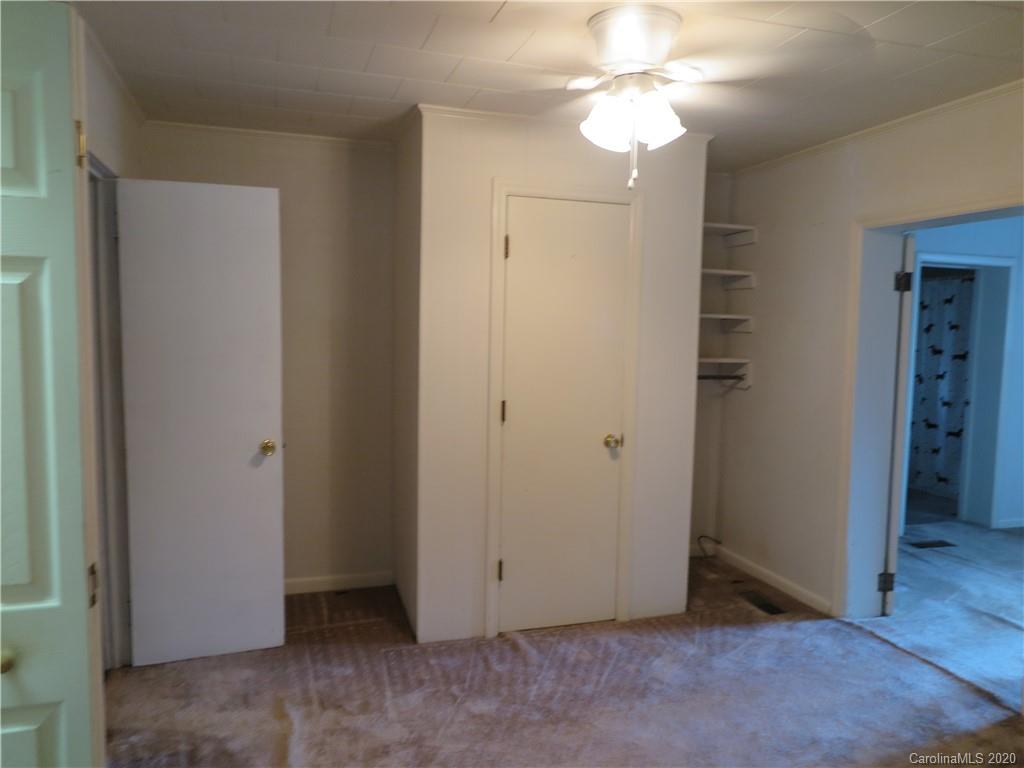 515 Upper Spencer Mountain Road Stanley, NC 28164 - Photo 23 of 28 an empty room with closet and a chandelier fan