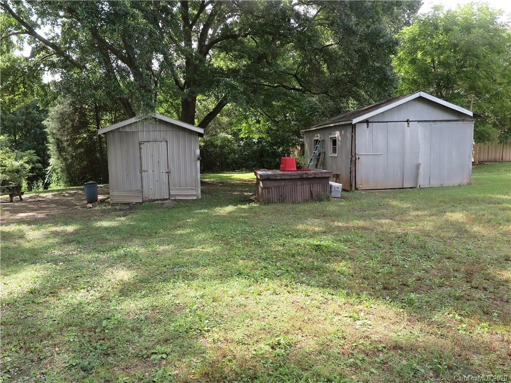 515 Upper Spencer Mountain Road Stanley, NC 28164 - Photo 25 of 28 a view of a backyard with wooden fence and a bench
