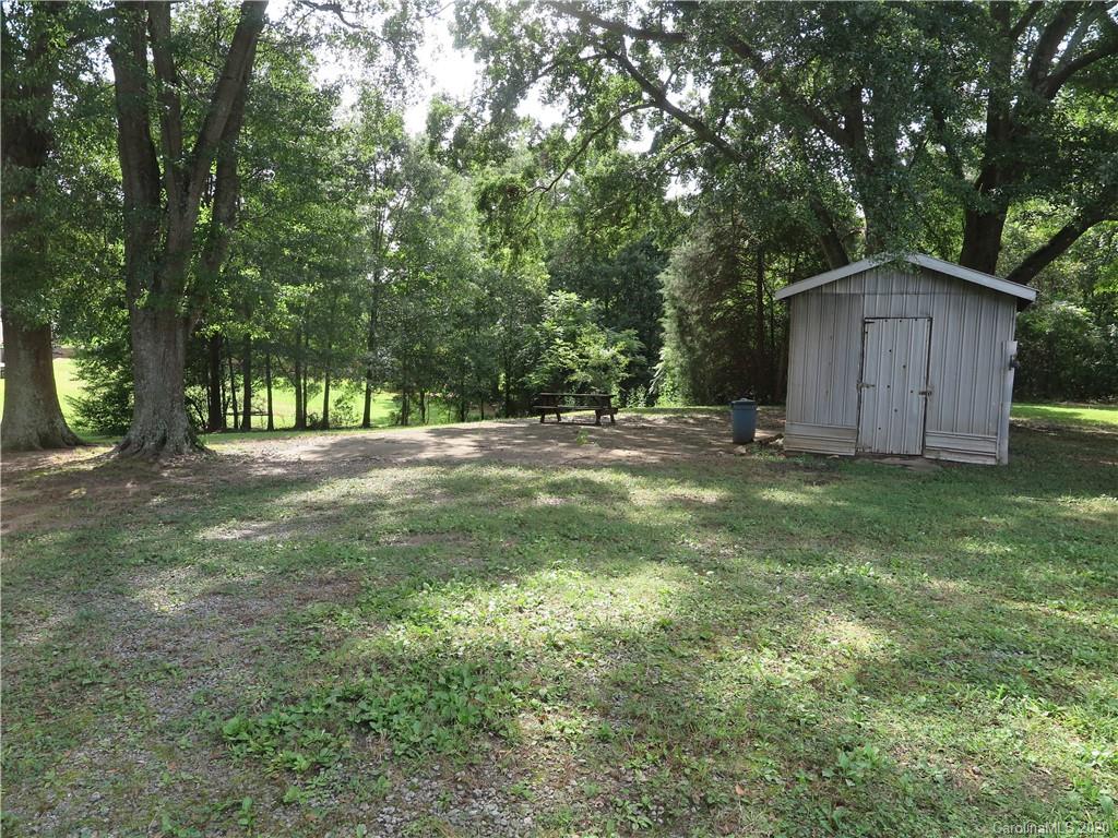515 Upper Spencer Mountain Road Stanley, NC 28164 - Photo 26 of 28 a view of a tree in a yard with large trees