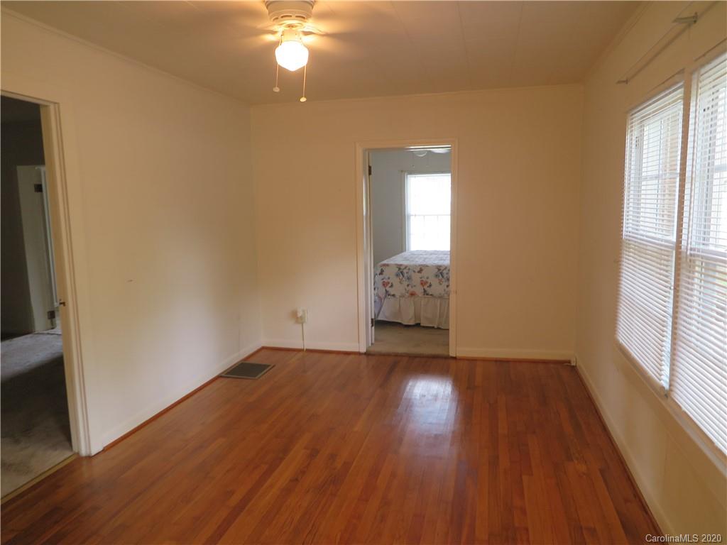 515 Upper Spencer Mountain Road Stanley, NC 28164 - Photo 4 of 28 an empty room with wooden floor and windows