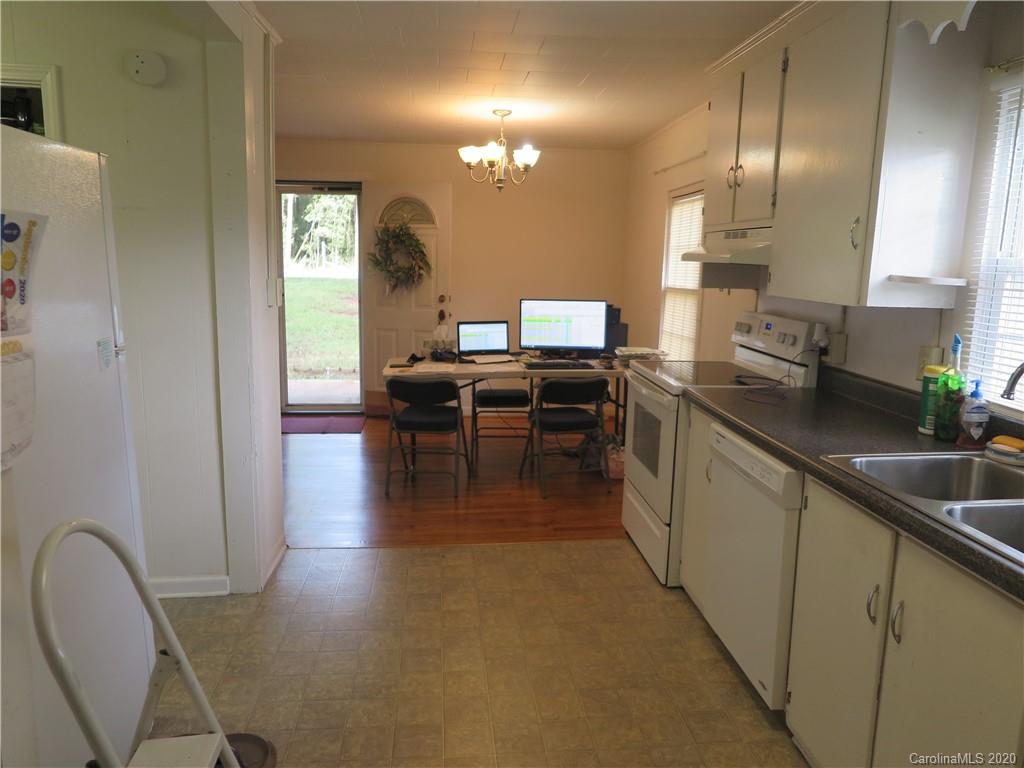 515 Upper Spencer Mountain Road Stanley, NC 28164 - Photo 5 of 28 a kitchen with kitchen island granite countertop a sink a counter top space and stainless steel appliances