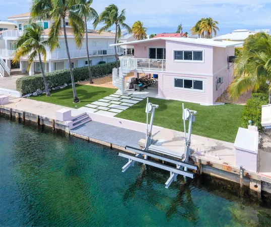 a view of a patio with table and chairs under an umbrella