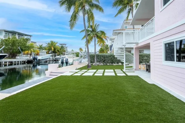 a view of a swimming pool with a garden and plants