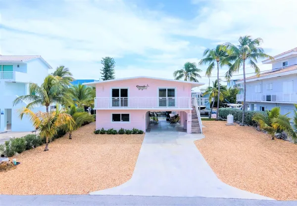 a front view of a house with a yard and a garage