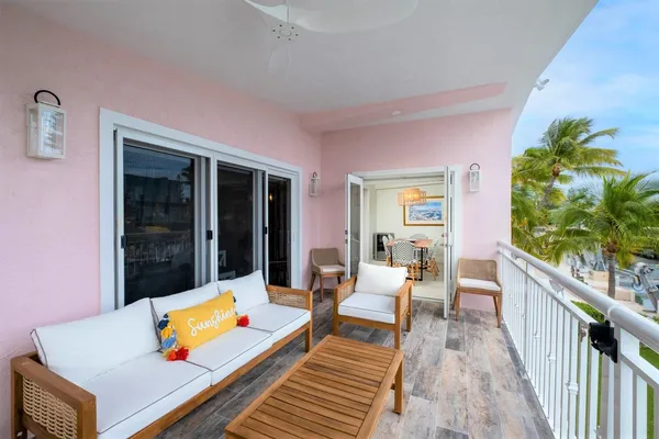 a bedroom with furniture a chandelier and a large window