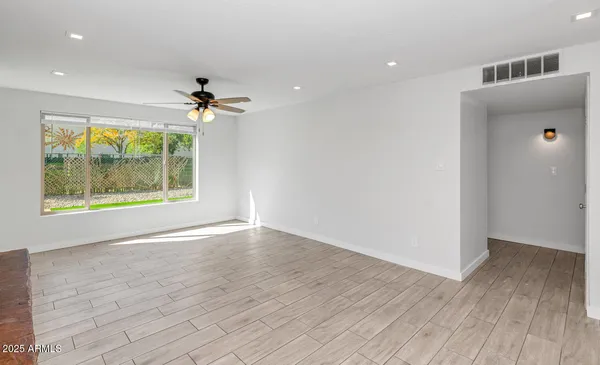 a view of a livingroom with a hardwood floor and a ceiling fan
