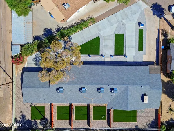 an aerial view of a house with yard and patio