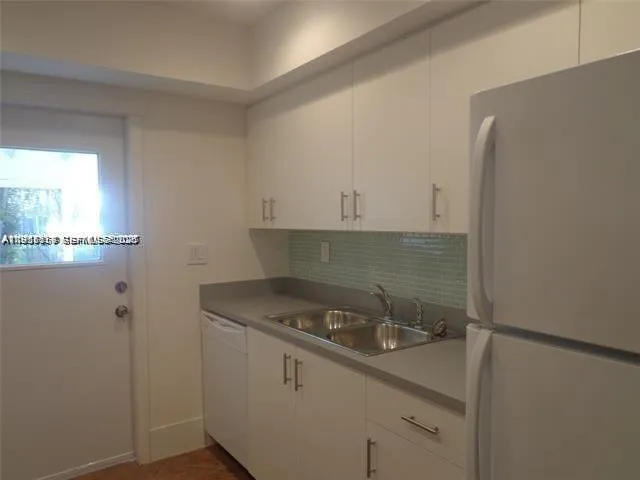 a utility room with cabinets