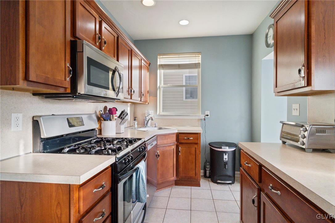 627 9th Avenue Bethlehem, PA 18018 - Photo 15 of 29 a kitchen with stainless steel appliances granite countertop a stove a sink and a microwave