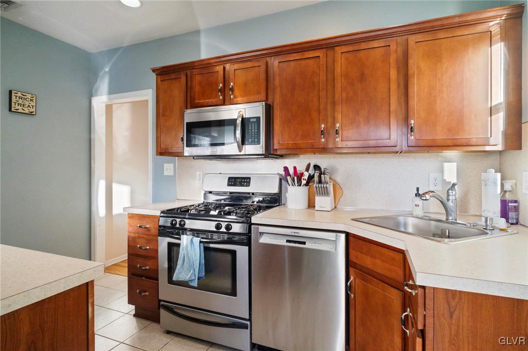 627 9th Avenue Bethlehem, PA 18018 - Photo 16 of 29 a kitchen with stainless steel appliances a stove a sink and a microwave