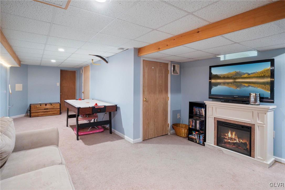 627 9th Avenue Bethlehem, PA 18018 - Photo 18 of 29 a living room with furniture a flat screen tv and a fireplace