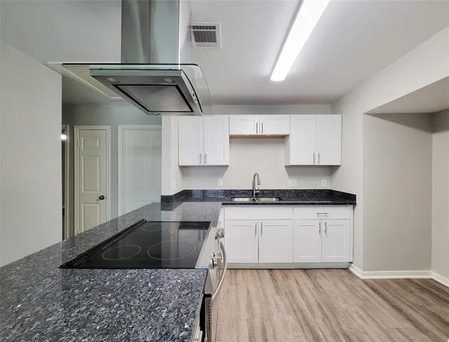 a kitchen with stainless steel appliances granite countertop a sink and cabinets