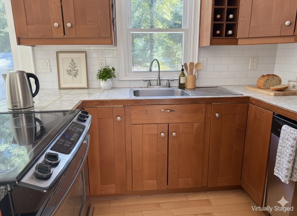 526 Skunknet Road Barnstable, MA 02632 - Photo 13 of 20 a kitchen with stainless steel appliances granite countertop a sink stove and cabinets