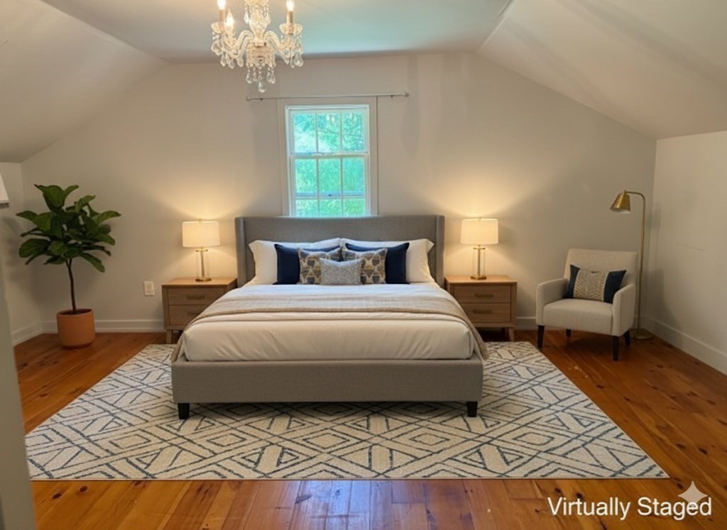 526 Skunknet Road Barnstable, MA 02632 - Photo 17 of 20 a bedroom with a bed lamp and a potted plant