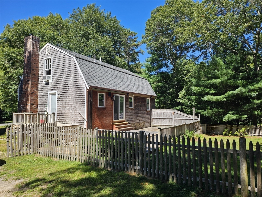 526 Skunknet Road Barnstable, MA 02632 - Photo 2 of 20 a front view of a house with a garden