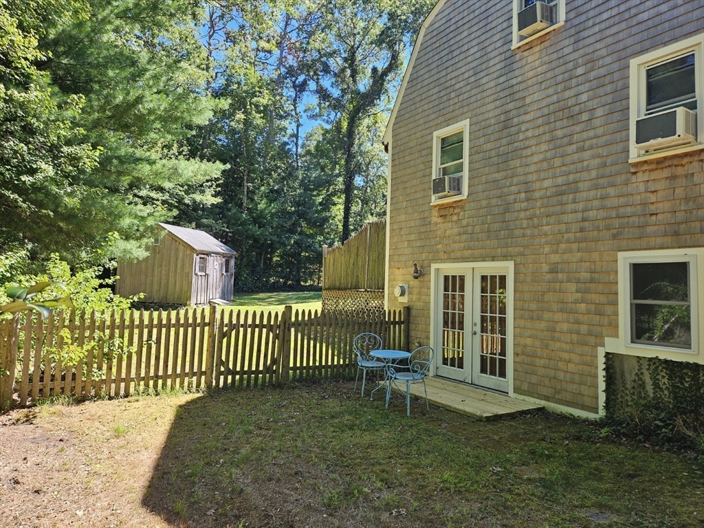 526 Skunknet Road Barnstable, MA 02632 - Photo 3 of 20 a view of a chair and table in backyard