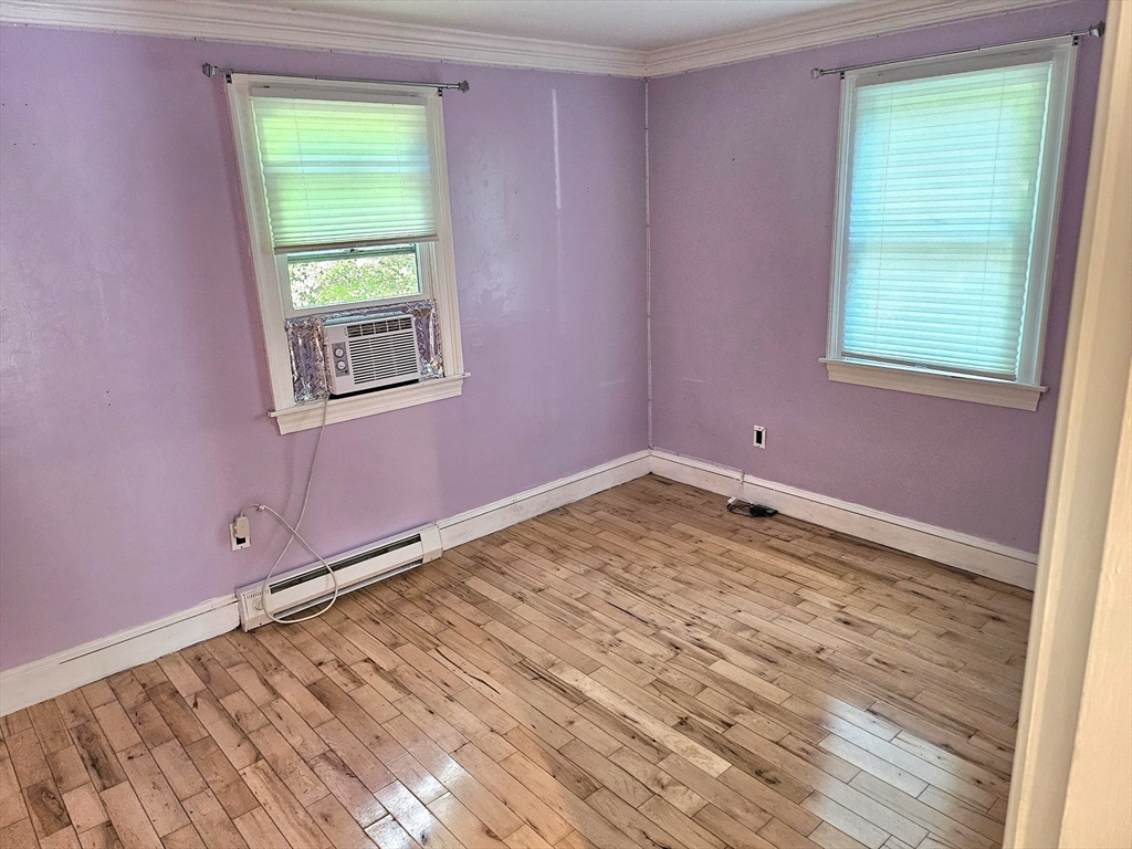 526 Skunknet Road Barnstable, MA 02632 - Photo 8 of 20 an empty room with a window and a wooden floor