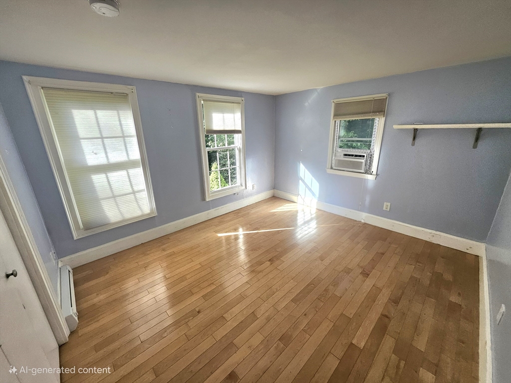 526 Skunknet Road Barnstable, MA 02632 - Photo 9 of 20 a view of an empty room with wooden floor and a window