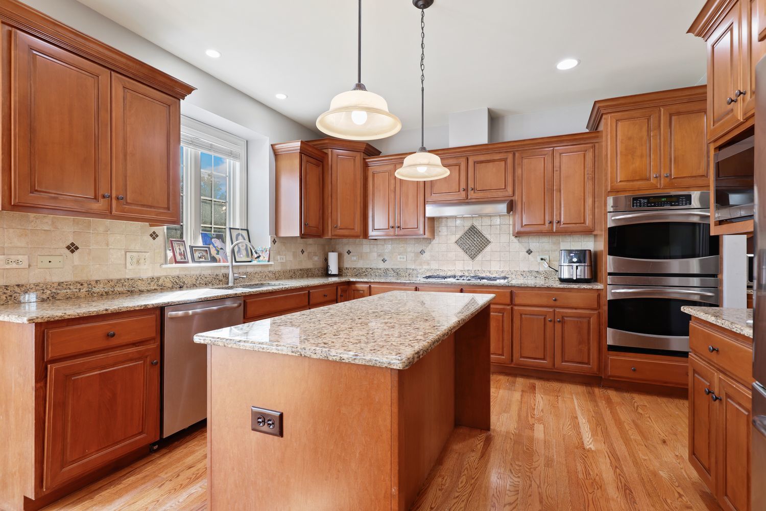 2524 Spartina Road Naperville, IL 60564 - Photo 9 of 41 a kitchen with stainless steel appliances granite countertop a sink a stove and a refrigerator