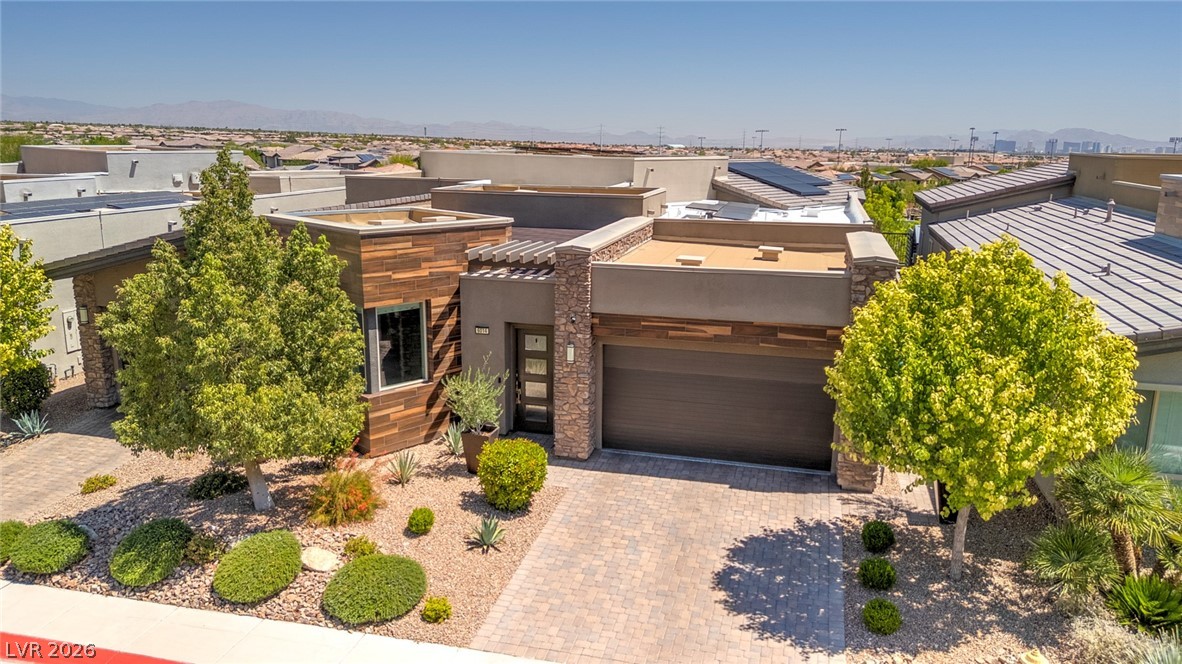 6014 Willow Ridge Court Las Vegas, NV 89135 - Photo 83 of 99 This contemporary home boasts a paved driveway, desert-friendly landscaping, and solar panels for sustainable living.