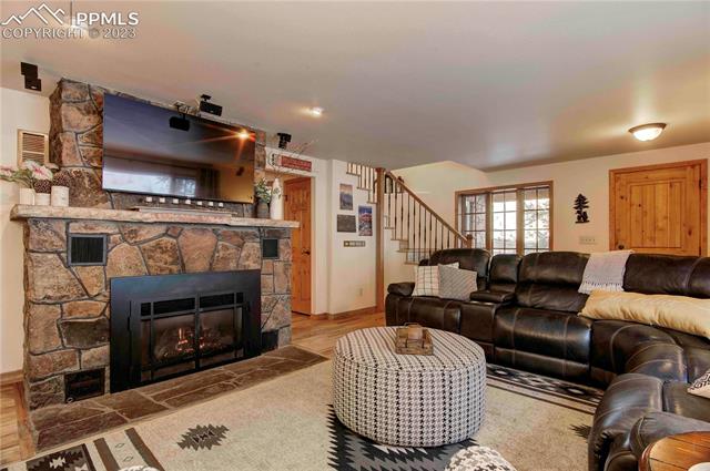 5790 Ona Road Cascade, CO 80809 - Photo 6 of 32 Living room with curved staircase to upper level.