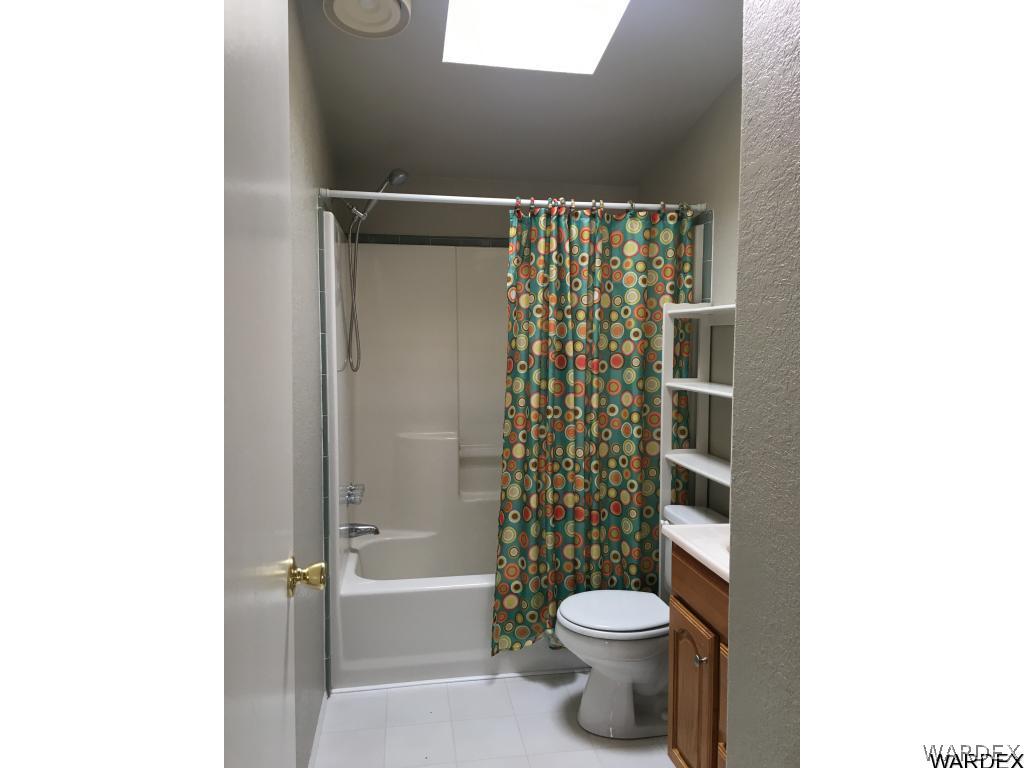 3192 Keystone Road Golden Valley, AZ 86413 - Photo 16 of 36 a bathroom with a toilet and a shower