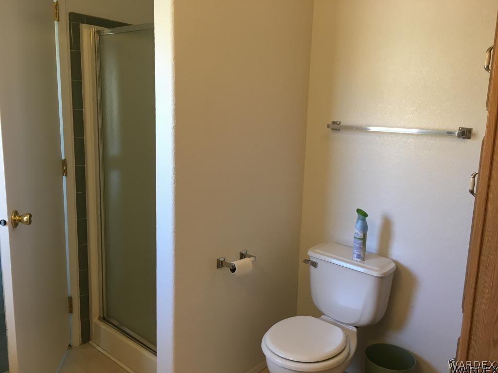 3192 Keystone Road Golden Valley, AZ 86413 - Photo 22 of 36 a white toilet sitting next to a bathroom sink
