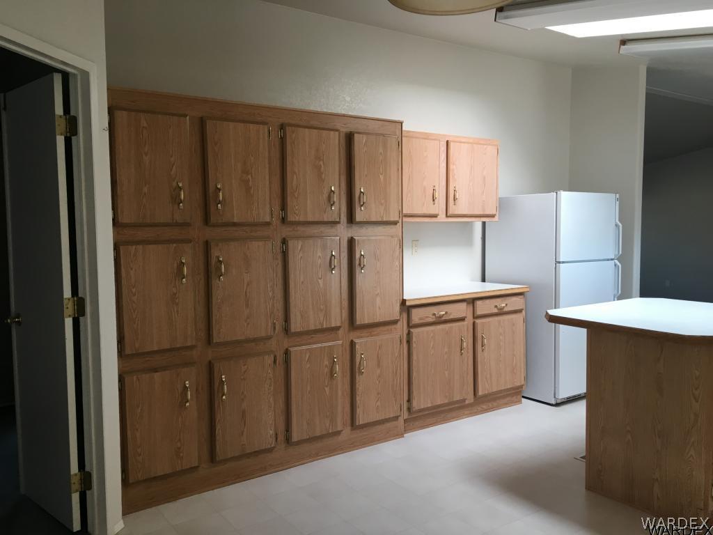 3192 Keystone Road Golden Valley, AZ 86413 - Photo 25 of 36 a kitchen with cabinets and stainless steel appliances