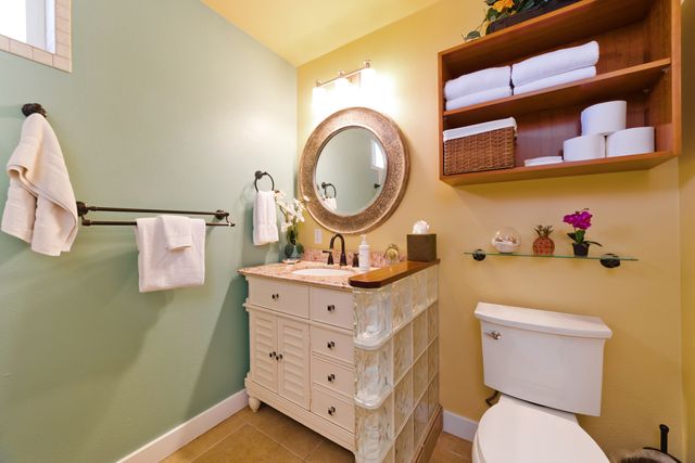 a bathroom with a toilet a sink and a mirror