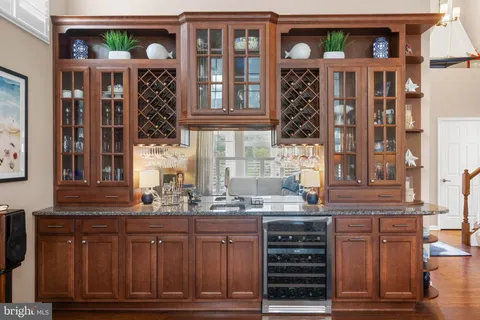 a kitchen with granite countertop a sink cabinets and wooden floor