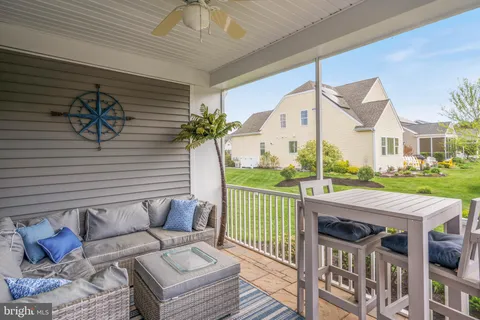 a wooden bench sitting in front of a house