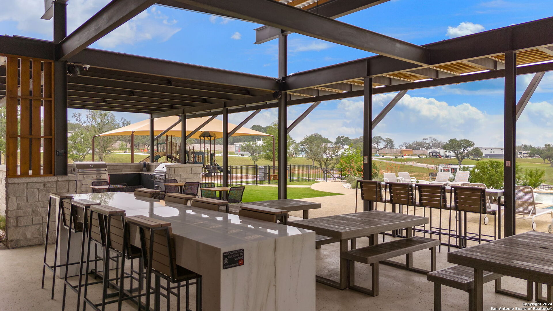 5386 Ranch Road 1376, Unit 372 Fredericksburg, TX 78624 - Photo 17 of 22 a view of a patio with a table chairs and a small yard