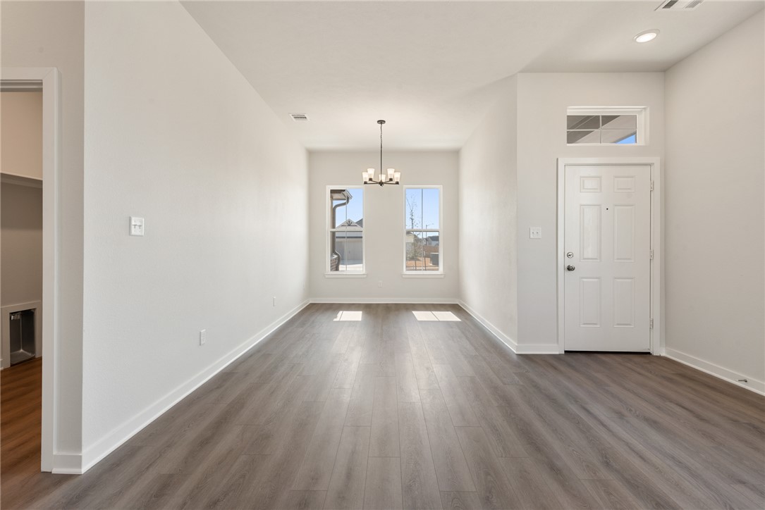 2220 Amber Court Bryan, TX 77807 - Photo 13 of 35 an empty room with wooden floor and windows