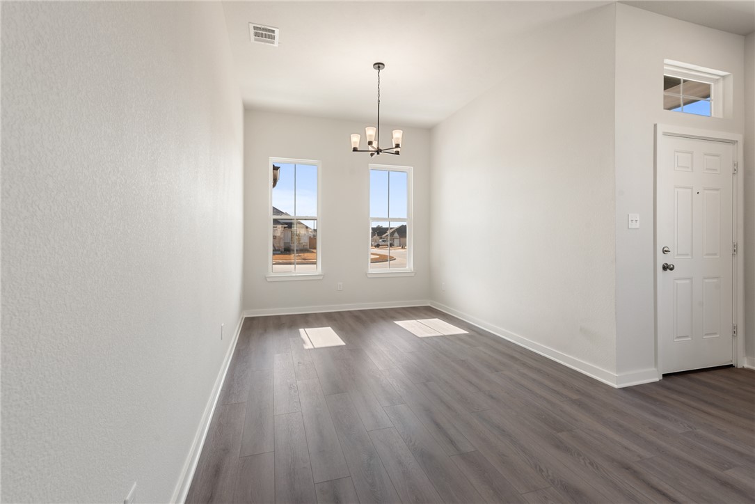 2220 Amber Court Bryan, TX 77807 - Photo 14 of 35 an empty room with wooden floor and windows