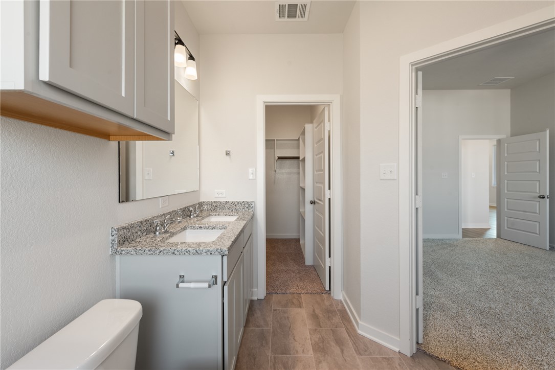 2220 Amber Court Bryan, TX 77807 - Photo 26 of 35 a bathroom with a granite countertop sink and a mirror