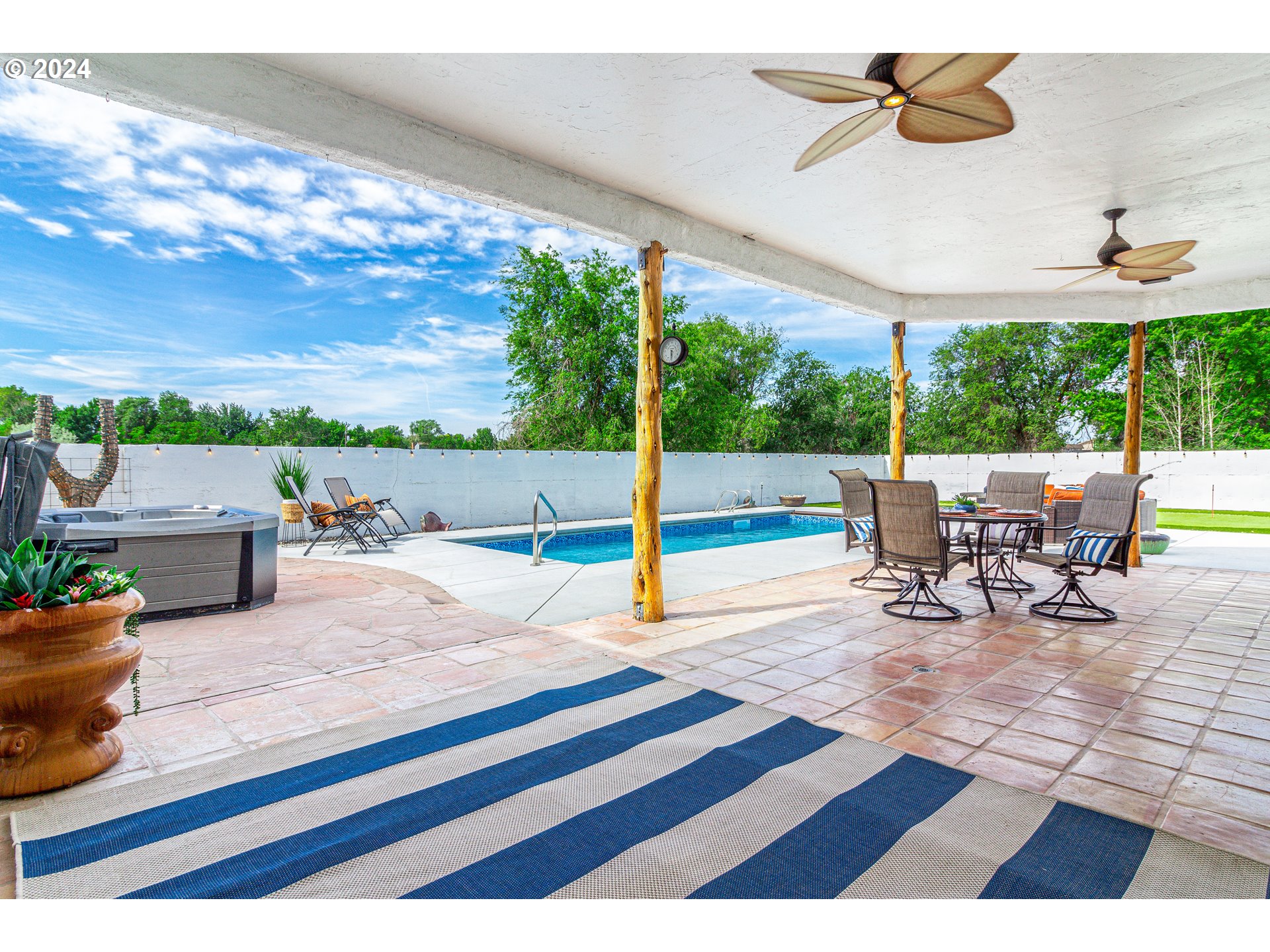 832 East Main Street Hermiston, OR 97838 - Photo 44 of 48 a view of a patio with a dining table and chairs with wooden floor