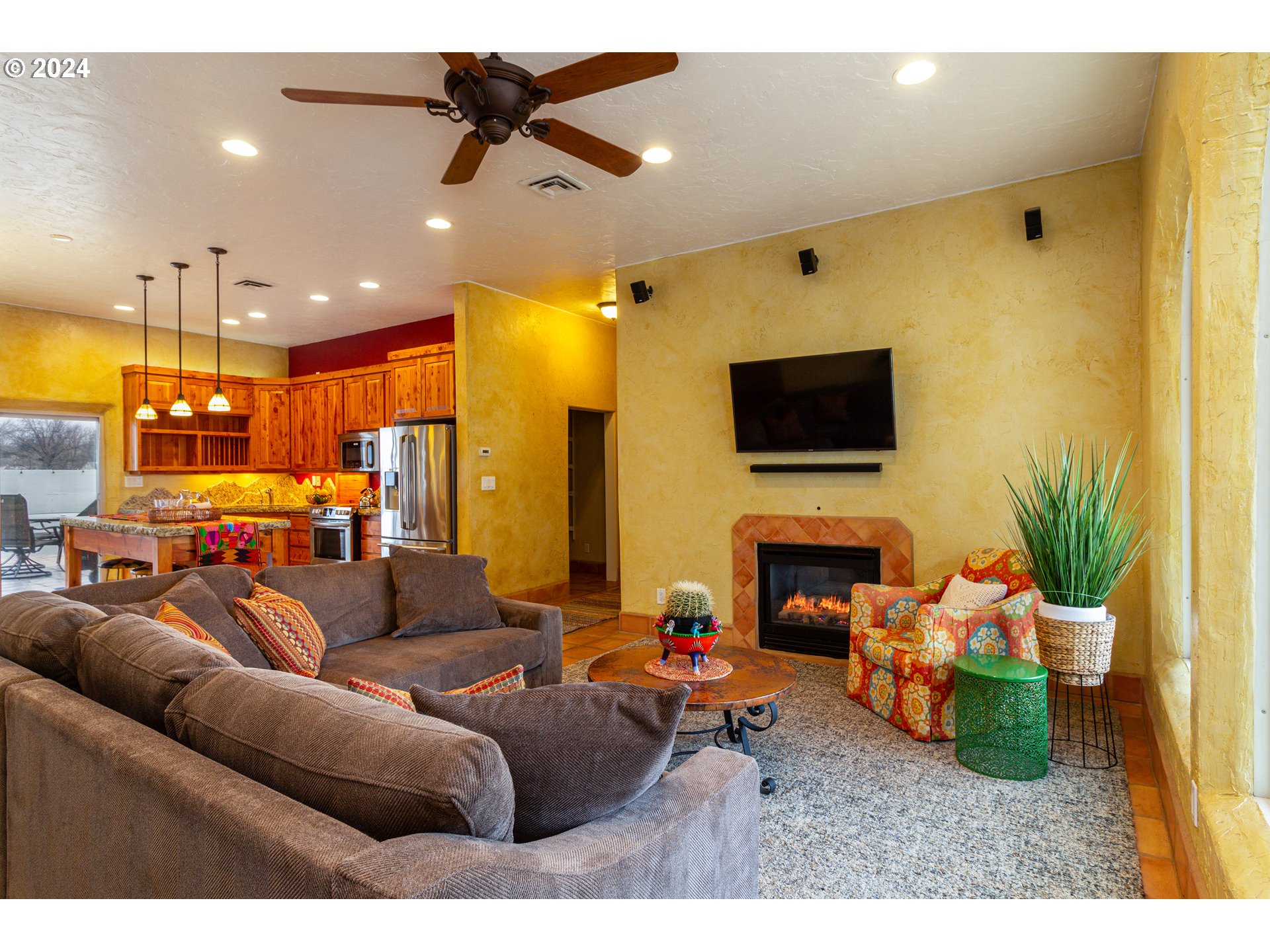 832 East Main Street Hermiston, OR 97838 - Photo 6 of 48 a living room with furniture a fireplace and a flat screen tv