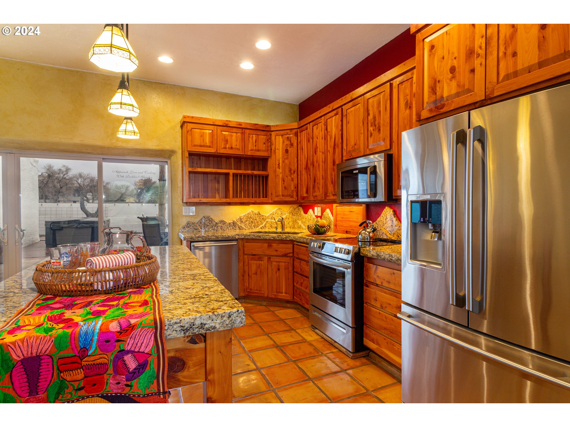 832 East Main Street Hermiston, OR 97838 - Photo 9 of 48 a kitchen with stainless steel appliances granite countertop a refrigerator and a stove