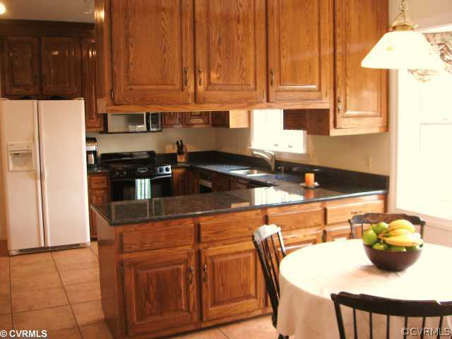5841 Deep Forest Road Chester, VA 23831 - Photo 7 of 12 a kitchen with stainless steel appliances granite countertop a sink a stove and a refrigerator