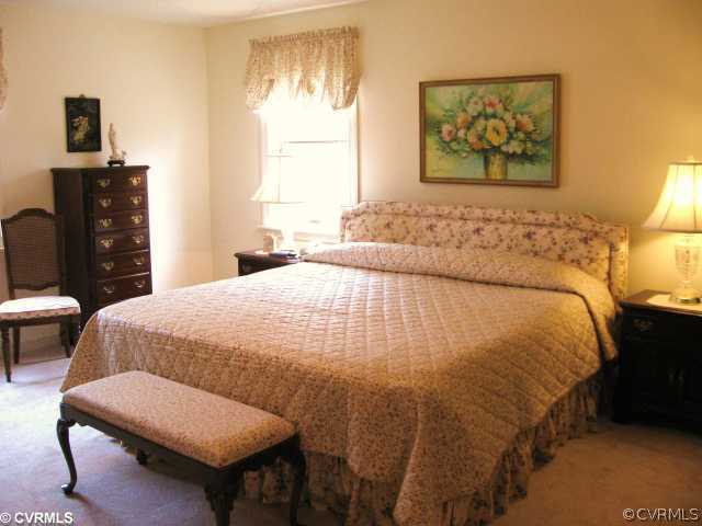 5841 Deep Forest Road Chester, VA 23831 - Photo 8 of 12 a bedroom with a bed and wooden floor