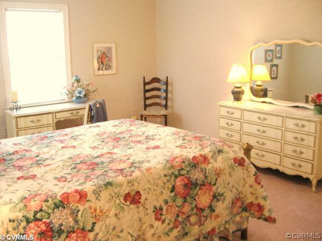 5841 Deep Forest Road Chester, VA 23831 - Photo 9 of 12 a bedroom with a bed and a dresser