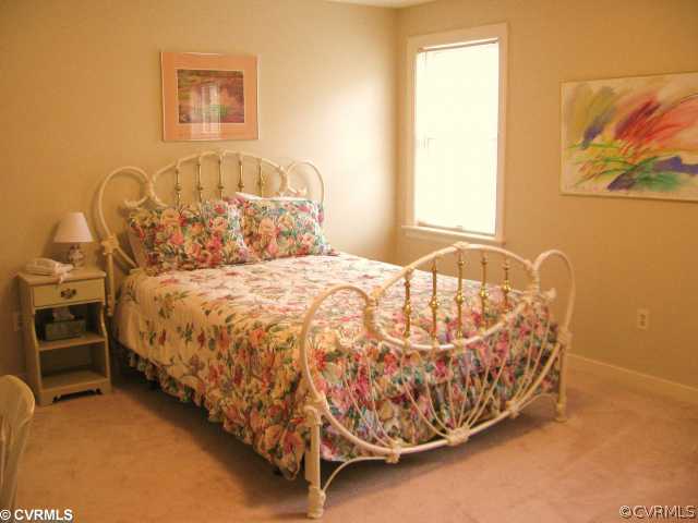 5841 Deep Forest Road Chester, VA 23831 - Photo 10 of 12 a bed sitting in a room next to a window