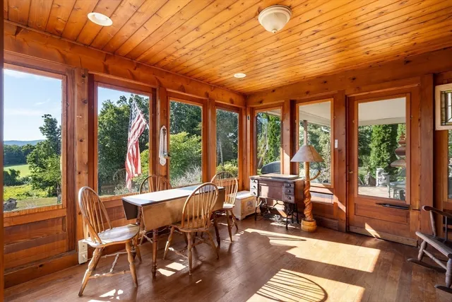 a view of a porch with furniture and garden