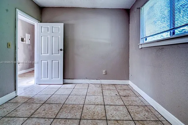a view of a kitchen with a refrigerator and a stove top oven