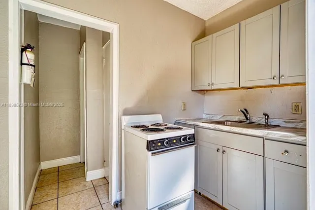 a view of kitchen island with stainless steel appliances wooden floor