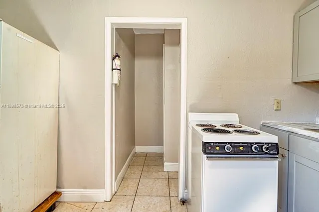 a kitchen with a refrigerator sink and cabinets
